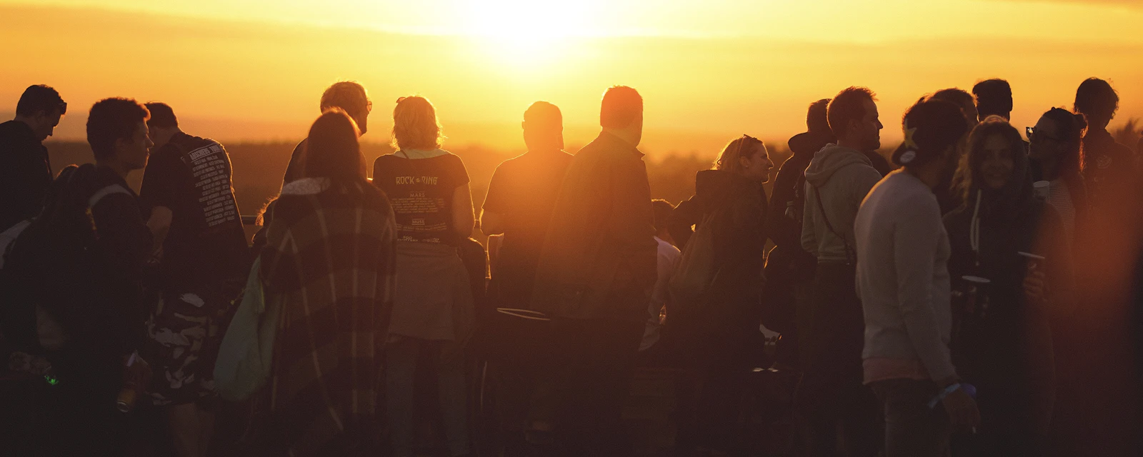 Music festival crowd in warm golden hour light